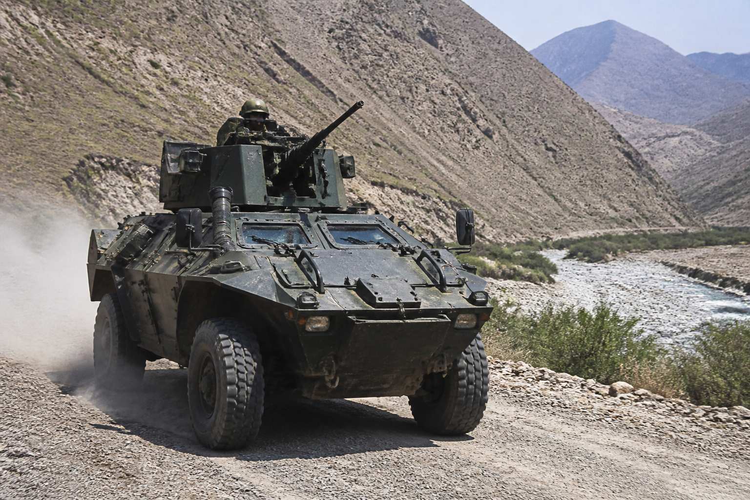 Wheeled armored military patrol vehicle on a desert road